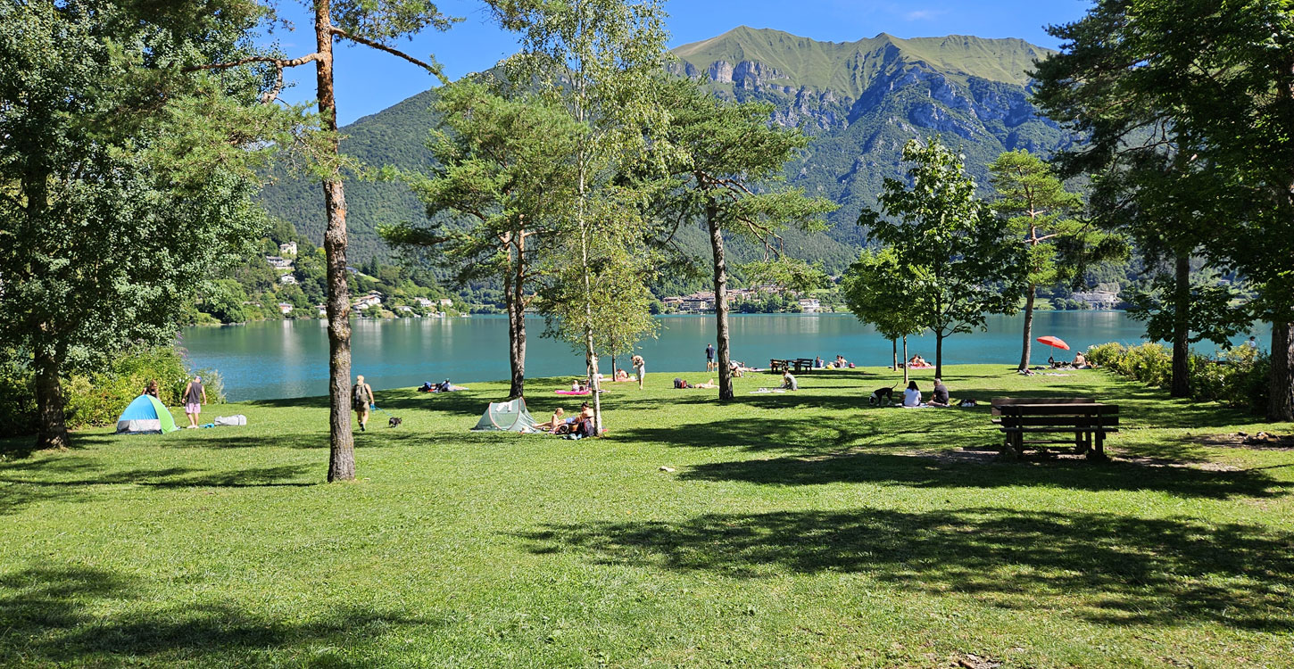 Cane che gioca sulla spiaggia per cani al Lago di Ledro